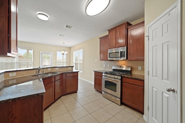 8727 Debbie Terrace Dr, Cypress, TX 77433 - kitchen featuring stainless steel appliances, a sink, backsplash, and healthy amount of natural light