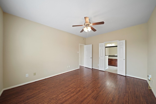 8727 Debbie Terrace Dr, Cypress, TX 77433 - unfurnished bedroom with wood finished floors, baseboards, ensuite bathroom, and ceiling fan