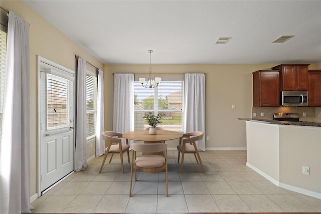 8727 Debbie Terrace Dr, Cypress, TX 77433 - dining room with a chandelier, light tile patterned floors, and baseboards