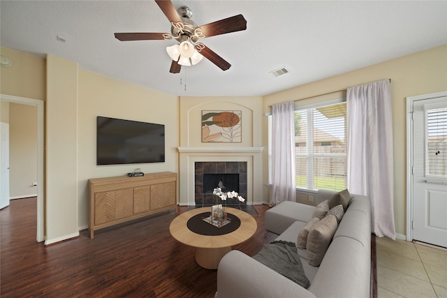 8727 Debbie Terrace Dr, Cypress, TX 77433 - living room with a tile fireplace, a ceiling fan, healthy amount of natural light, and baseboards