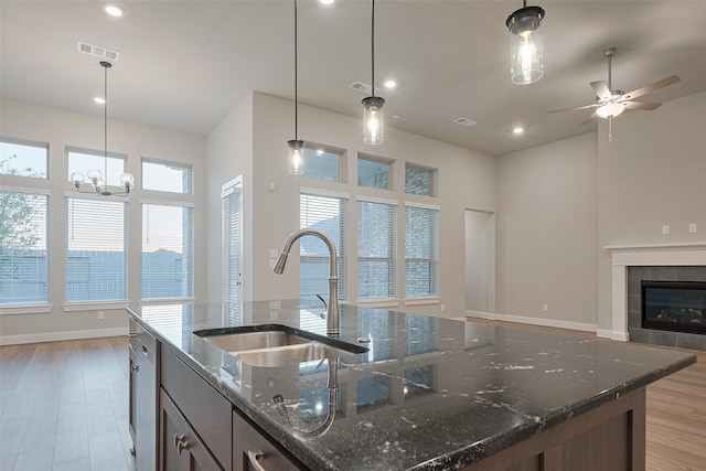 5106 Blooming Hibiscus Ln, Manvel, TX 77578 - kitchen with a sink, a center island with sink, open floor plan, light wood-type flooring, and recessed lighting