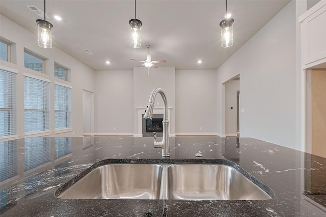 5106 Blooming Hibiscus Ln, Manvel, TX 77578 - kitchen with a sink, dark stone counters, a ceiling fan, white cabinetry, and recessed lighting