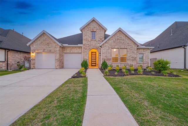 5106 Blooming Hibiscus Ln, Manvel, TX 77578 - view of front of property featuring brick siding, concrete driveway, a garage, and a front yard