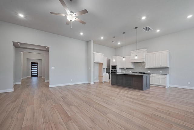 5106 Blooming Hibiscus Ln, Manvel, TX 77578 - kitchen featuring a sink, open floor plan, dark countertops, white cabinetry, and recessed lighting