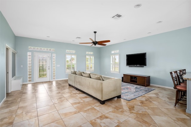 815 5th St, San Leon, TX 77539 - living area featuring ceiling fan, light tile patterned floors, and baseboards
