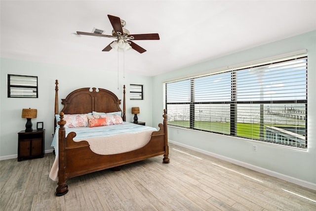 815 5th St, San Leon, TX 77539 - bedroom with wood finished floors, baseboards, and ceiling fan