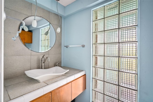 815 5th St, San Leon, TX 77539 - bathroom featuring tasteful backsplash, vanity, and tile walls