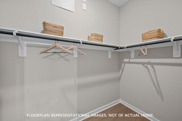8043 Kay Harbor Dr, Cypress, TX 77433 - spacious closet featuring dark wood-type flooring