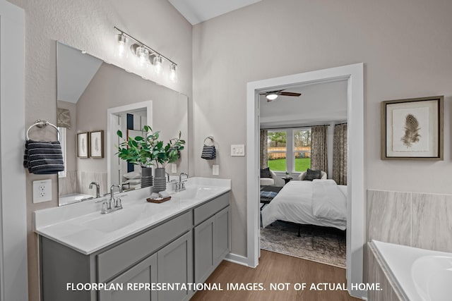 8043 Kay Harbor Dr, Cypress, TX 77433 - bathroom with double vanity, wood finished floors, a bath, connected bathroom, and a ceiling fan