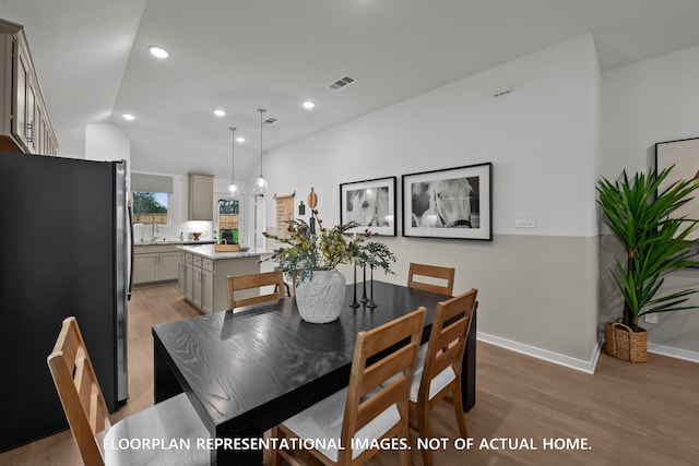 8043 Kay Harbor Dr, Cypress, TX 77433 - dining area with light wood-style flooring, baseboards, recessed lighting, and vaulted ceiling