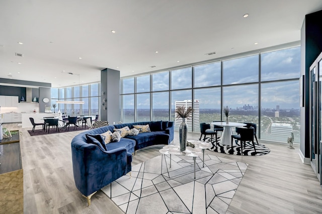 4521 San Felipe St Unit 2701, Houston, TX 77027 - living room featuring light wood-type flooring, plenty of natural light, a view of city, and floor to ceiling windows