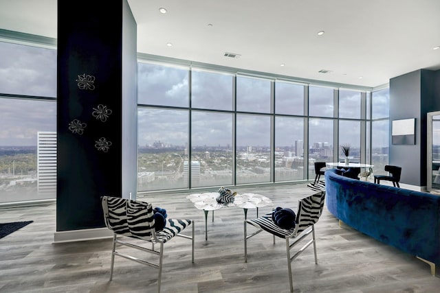 4521 San Felipe St Unit 2701, Houston, TX 77027 - living area featuring floor to ceiling windows, wood finished floors, and a city view