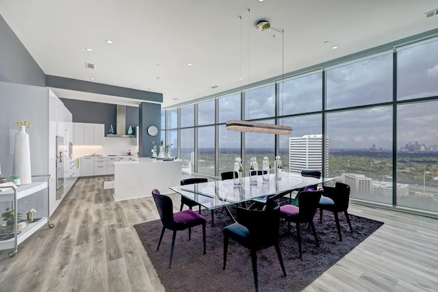 4521 San Felipe St Unit 2701, Houston, TX 77027 - dining room with floor to ceiling windows and light wood-style floors