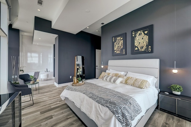 4521 San Felipe St Unit 2701, Houston, TX 77027 - bedroom with wood finished floors, arched walkways, and baseboards