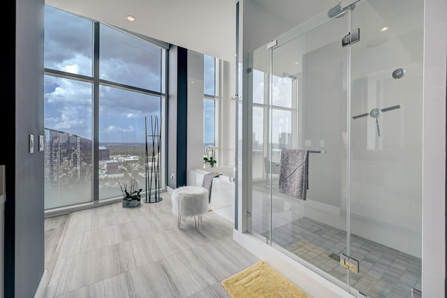 4521 San Felipe St Unit 2701, Houston, TX 77027 - full bathroom with a wall of windows, a shower stall, a tub, tile patterned flooring, and a view of city
