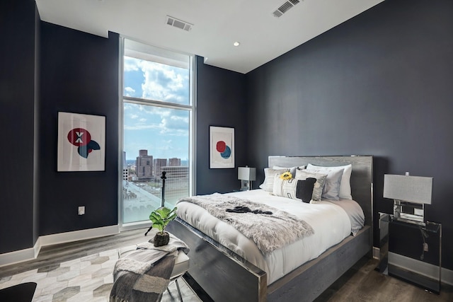 4521 San Felipe St Unit 2701, Houston, TX 77027 - bedroom featuring wood finished floors, floor to ceiling windows, baseboards, and access to outside