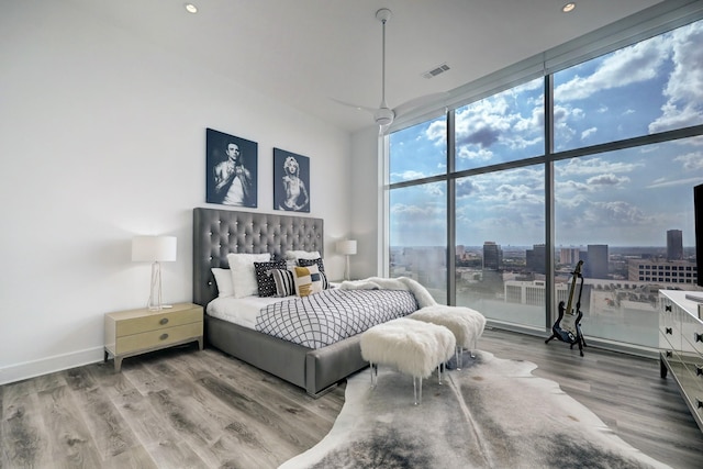 4521 San Felipe St Unit 2701, Houston, TX 77027 - bedroom featuring floor to ceiling windows, wood finished floors, recessed lighting, and baseboards