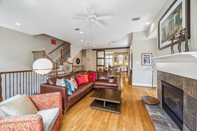 574 Bomar St, Houston, TX 77006 - living area featuring a ceiling fan, a fireplace, stairway, light wood-style flooring, and recessed lighting