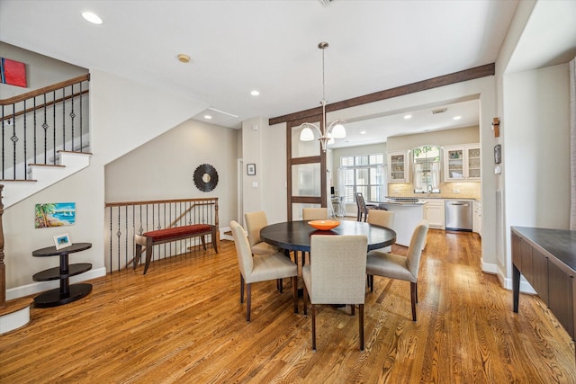 574 Bomar St, Houston, TX 77006 - dining area featuring light wood-style flooring, recessed lighting, a chandelier, stairway, and baseboards