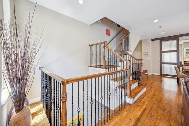 574 Bomar St, Houston, TX 77006 - stairway with wood finished floors, recessed lighting, and baseboards