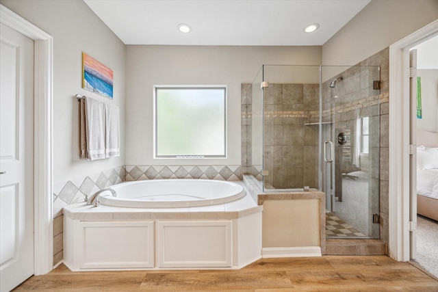 574 Bomar St, Houston, TX 77006 - bathroom featuring a garden tub, a shower stall, and wood finished floors