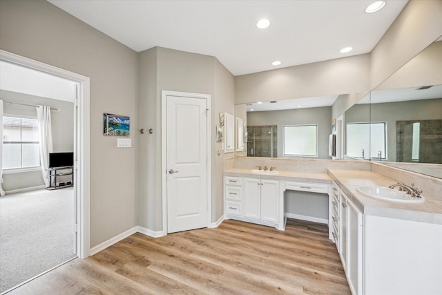574 Bomar St, Houston, TX 77006 - full bathroom featuring double vanity, a tile shower, wood finished floors, recessed lighting, and baseboards