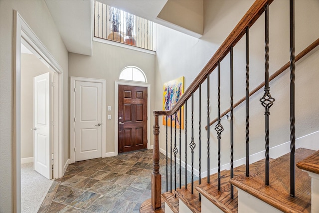 574 Bomar St, Houston, TX 77006 - entryway featuring baseboards, stone finish floors, and stairway