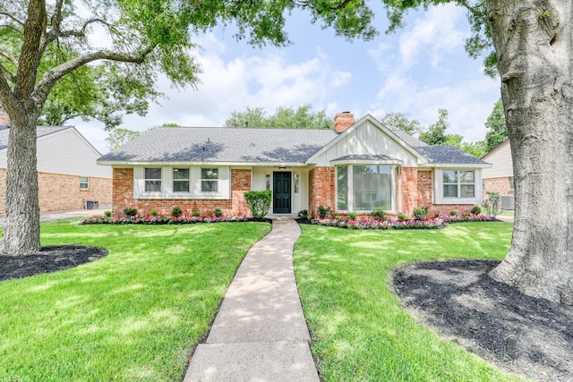 2519 Parana Dr, Houston, TX 77080 - single story home featuring brick siding, a chimney, a front lawn, and roof with shingles
