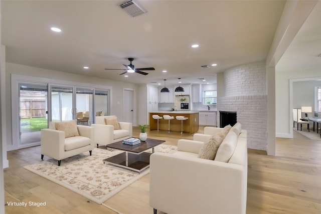 2519 Parana Dr, Houston, TX 77080 - living area featuring recessed lighting, light wood-type flooring, a ceiling fan, and a fireplace