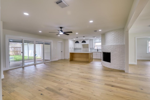 2519 Parana Dr, Houston, TX 77080 - unfurnished living room featuring light wood finished floors, ceiling fan, baseboards, recessed lighting, and a fireplace