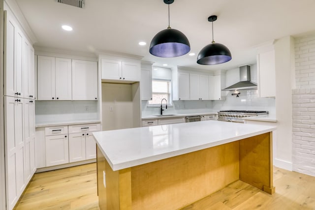2519 Parana Dr, Houston, TX 77080 - kitchen featuring wall chimney exhaust hood, a sink, light wood-type flooring, light countertops, and recessed lighting