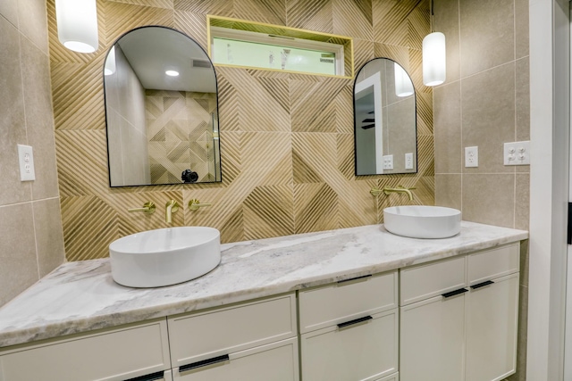 2519 Parana Dr, Houston, TX 77080 - full bathroom featuring tile walls, decorative backsplash, and double vanity