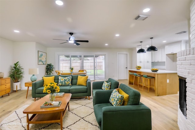 2519 Parana Dr, Houston, TX 77080 - living area with light wood finished floors, recessed lighting, a ceiling fan, and a fireplace
