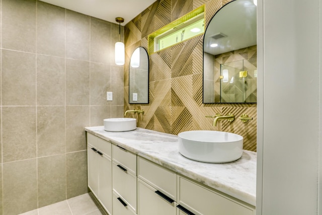 2519 Parana Dr, Houston, TX 77080 - bathroom with tile walls, double vanity, tile patterned floors, and tasteful backsplash
