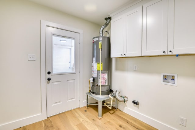 2519 Parana Dr, Houston, TX 77080 - laundry room featuring water heater, light wood finished floors, washer hookup, cabinet space, and baseboards