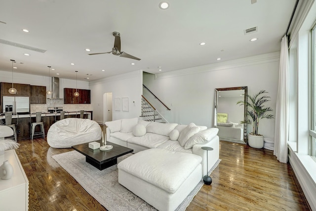 5317 Lillian St, Houston, TX 77007 - living room featuring stairs, ceiling fan, wood finished floors, ornamental molding, and recessed lighting
