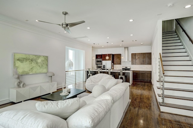 5317 Lillian St, Houston, TX 77007 - living area with stairs, recessed lighting, dark wood finished floors, crown molding, and a ceiling fan