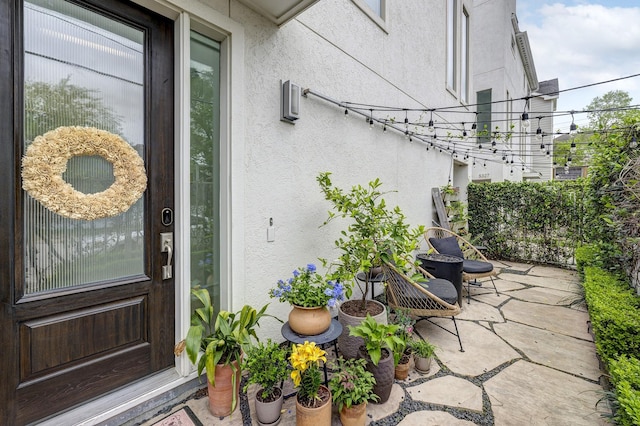 5317 Lillian St, Houston, TX 77007 - view of exterior entry featuring stucco siding and a patio area