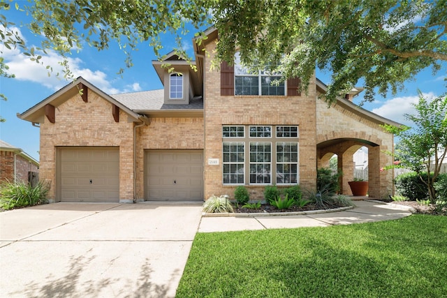 25303 Hall Meadow Ln, Katy, TX 77494 - traditional-style home featuring concrete driveway, a front yard, a shingled roof, a garage, and brick siding