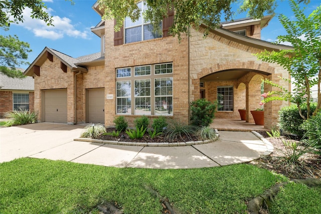 25303 Hall Meadow Ln, Katy, TX 77494 - view of front of property with driveway, stone siding, brick siding, and an attached garage