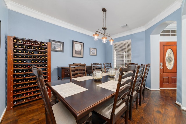 25303 Hall Meadow Ln, Katy, TX 77494 - dining room with ornamental molding, wood finished floors, arched walkways, and baseboards