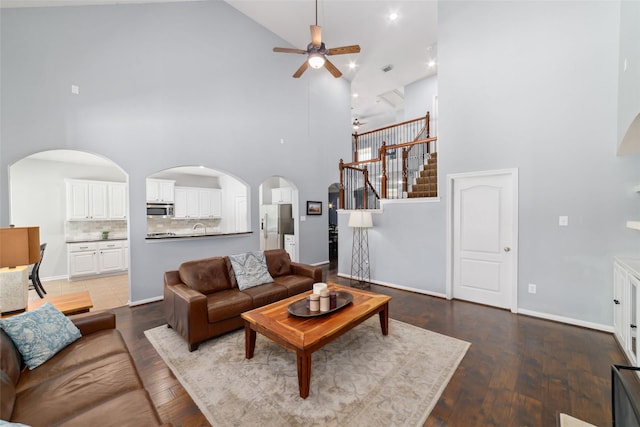 25303 Hall Meadow Ln, Katy, TX 77494 - living area featuring high vaulted ceiling, ceiling fan, stairs, wood finished floors, and arched walkways