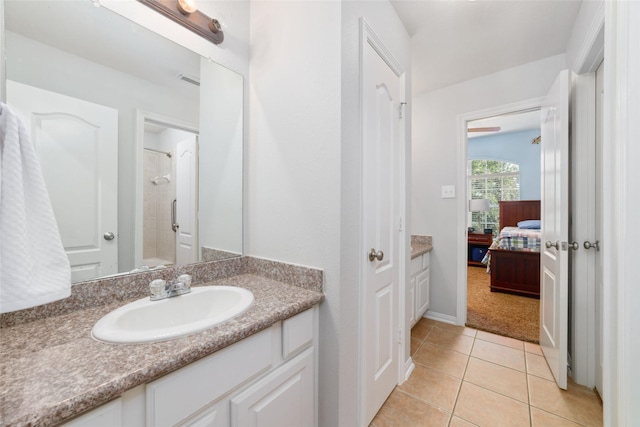 25303 Hall Meadow Ln, Katy, TX 77494 - ensuite bathroom featuring vanity, a shower, tile patterned flooring, and baseboards