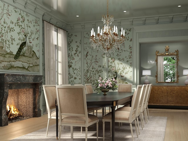 10 Courtlandt Pl, Houston, TX 77006 - dining space featuring wood finished floors, a chandelier, wallpapered walls, a high end fireplace, and plenty of natural light