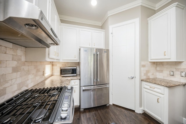 4311 Childress St, Houston, TX 77005 - kitchen featuring appliances with stainless steel finishes, under cabinet range hood, light stone countertops, white cabinetry, and ornamental molding