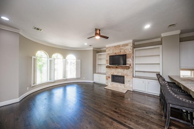 4311 Childress St, Houston, TX 77005 - unfurnished living room featuring crown molding, a ceiling fan, baseboards, a stone fireplace, and dark wood finished floors