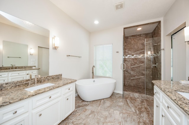 4311 Childress St, Houston, TX 77005 - full bathroom with a shower stall, two vanities, marble finish floors, a freestanding tub, and recessed lighting