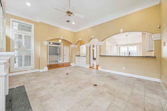 1214 Turnbury Oak Ln, Houston, TX 77055 - unfurnished living room featuring ceiling fan, arched walkways, a sink, light tile patterned flooring, and ornamental molding
