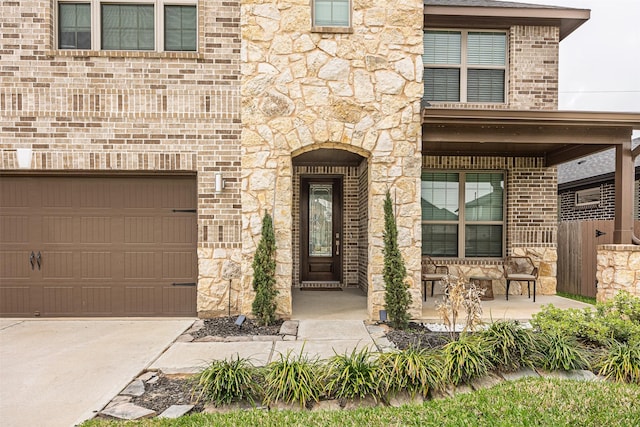 3330 Black Gore Creek Dr, Katy, TX 77494 - property entrance featuring stone siding, covered porch, and brick siding