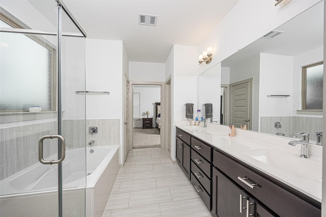 3330 Black Gore Creek Dr, Katy, TX 77494 - bathroom featuring a bath, double vanity, a shower with door, and plenty of natural light